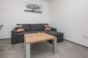 Family Apartment A1 | Living area | 100-cm flat-screen TV with satellite channels, TV