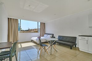 Family Room | Desk, laptop workspace, iron/ironing board, free WiFi - Inn & Out Sandton Park  (Sandton)