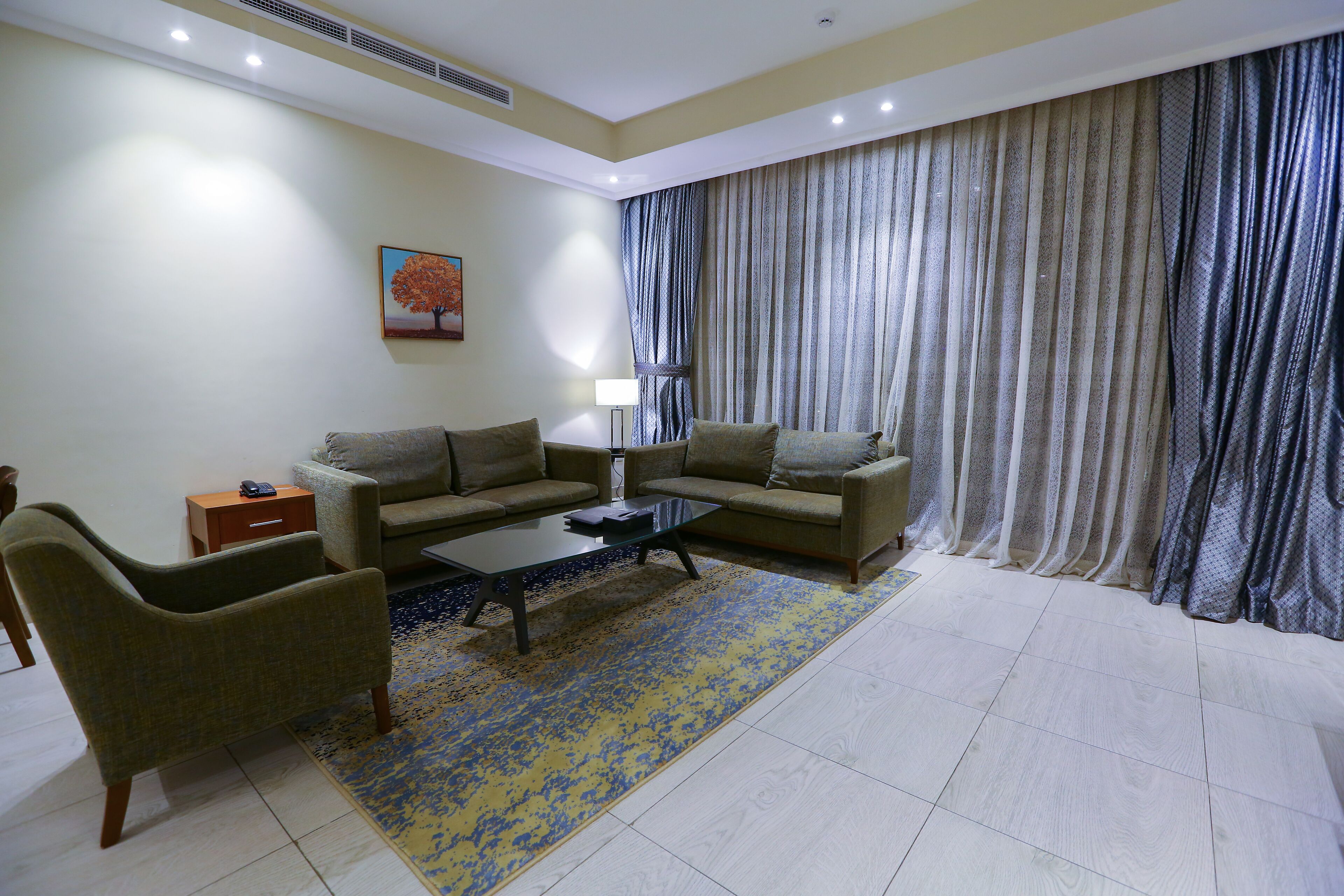 A living room with two sofas, a coffee table, and a lamp.