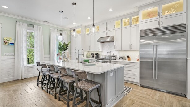 A modern kitchen with a central island, stainless steel appliances, and pendant lighting. - Renovated Seagrove Home with LSV & Pool Access (Santa Rosa Beach)