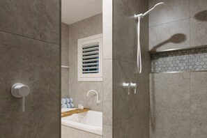 Bathtub, hair dryer, towels, shampoo