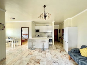 A compact living space with a kitchen, dining area, and a small seating area.