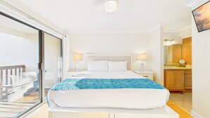 A hotel room with a bed, two bedside lamps, a balcony, and a view of the city skyline. - Sea Me 9E–Close to Beach–Sleeps 6 (Panama City Beach)