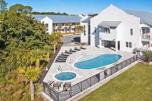 Relax by the inviting pool surrounded by lush greenery and trees.