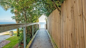 A wooden pathway leading to a beach with a wooden fence on one side and a railing on the other. - Old Seagrove "Thyme by the Sea" |3BR| 2 Kings| Sleeps 9| 250ft from Beach! (Santa Rosa Beach)