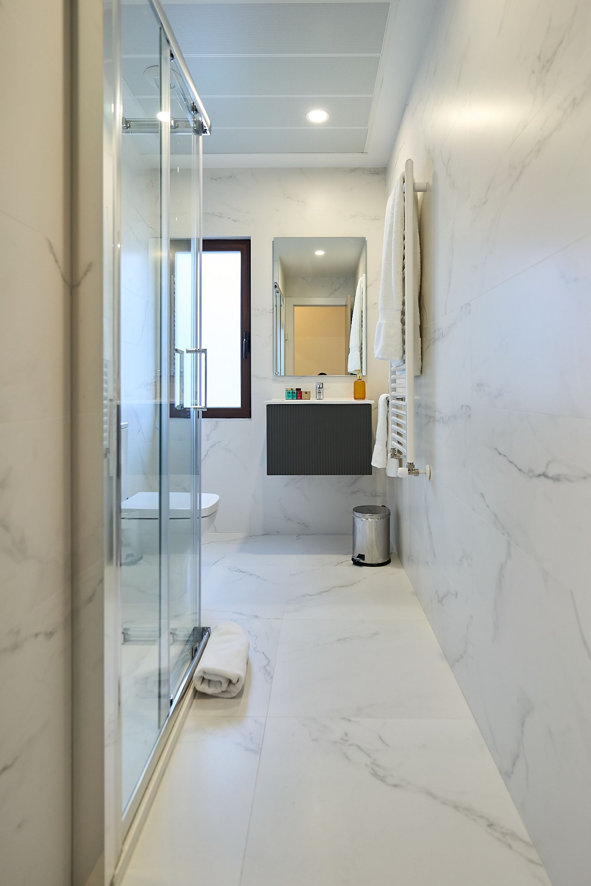 Shower, rainfall showerhead, hair dryer, towels