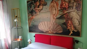 A bedroom with a large mural, a red headboard, and neatly folded towels on the bed. - The most glamorous lounge in downtown: romantic sensory and rock! (Bergamo)