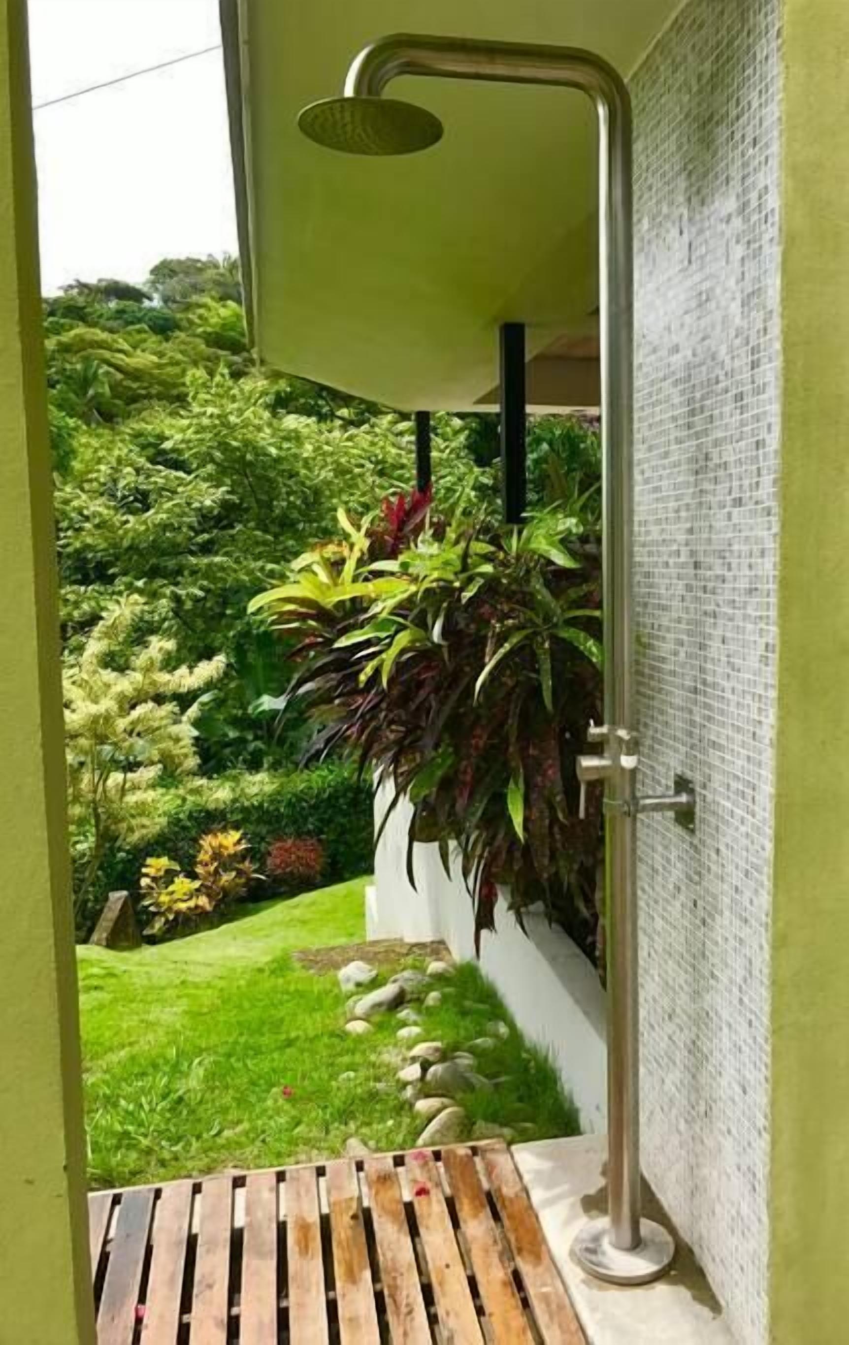 Une douche avec vue sur un jardin luxuriant.