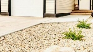 A two-story house with a garage, a front door, and a small porch. - Gorgeous townhome 5 min walk to the stunning lake. (Sylvan Lake)
