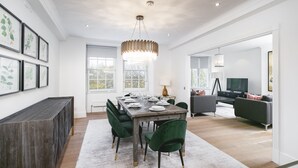 A spacious dining area with a wooden table set for six, surrounded by green upholstered chairs. - ' Luxury & Spacious AirCondisioned 4 Bed 4 Bath Apartment ' (London)