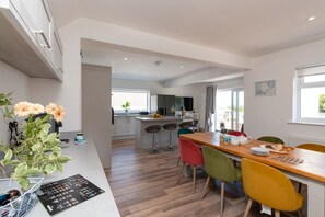Showstopper kitchen diner with island, induction hob, colourful bar stools and American fridge freezer, holiday home sleeping eight near Benllech Beach, Anglesey - Sandaig: Pet-Friendly Holiday Home Near Benllech Beach (Benllech)