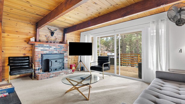 A cozy living room with a fireplace, a flat-screen TV, and comfortable seating. - CRESCENT TREE CABIN CLOSE TO BEAR MOUNTAIN, GOLF COURSE  AND THE ZOO (Big Bear Lake)