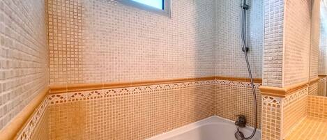 Bathtub, hair dryer, towels, soap