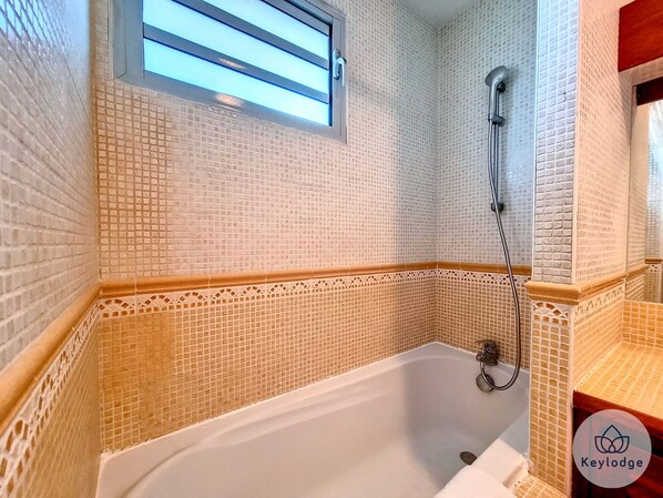 Bathtub, hair dryer, towels, soap