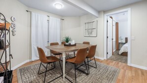 A dining area with a round table, four chairs, a rug, and a ceiling light. - Private/clean guest suite, bath, kitchen & laundry (South Jordan)