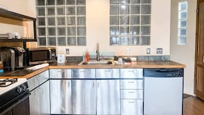A modern kitchen with stainless steel appliances, a wooden countertop, and a built-in dishwasher. - Awesome Location Steam Shower Hottub (Telluride)