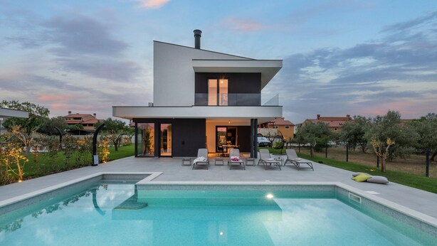 A modern two-story house with a swimming pool and outdoor seating. - Luxury Villa Monroe with Pool (Vodnjan)