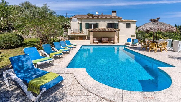 A swimming pool with lounge chairs, a building with a terrace, and a thatched umbrella. - Charming Pollensa Villa | Beautiful Views Of the Tramuntana Mountains | La. (Pollensa)