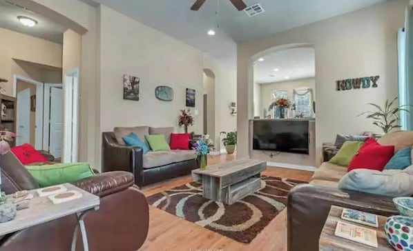 A spacious living room with a fireplace, a sofa set, and a coffee table.
