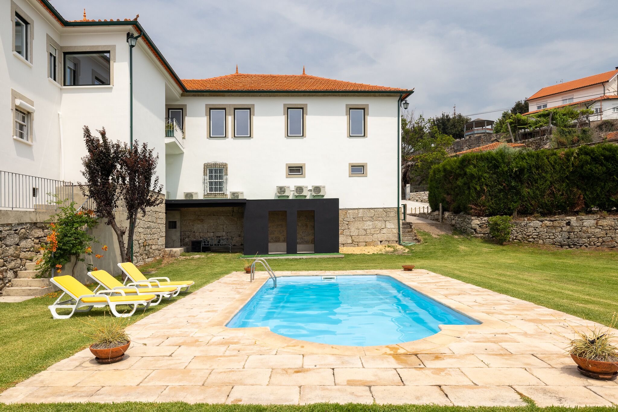 Una piscina al aire libre, sombrillas, tumbonas