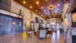 A spacious lobby with a cinema sign, wooden ceiling, and seating area. - 2967 Banana Palm Drive (Kissimmee)