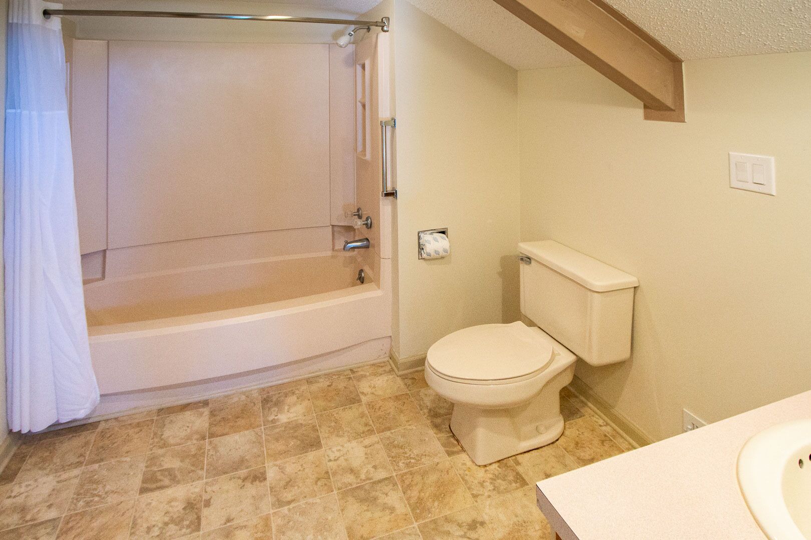 A bathroom with a bathtub, toilet, and sink.