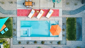 An aerial view of a swimming pool area with lounge chairs, a table, and a hot tub. - "The White Rabbit" Palm Springs--60's Inspired Pad (Palm Springs)