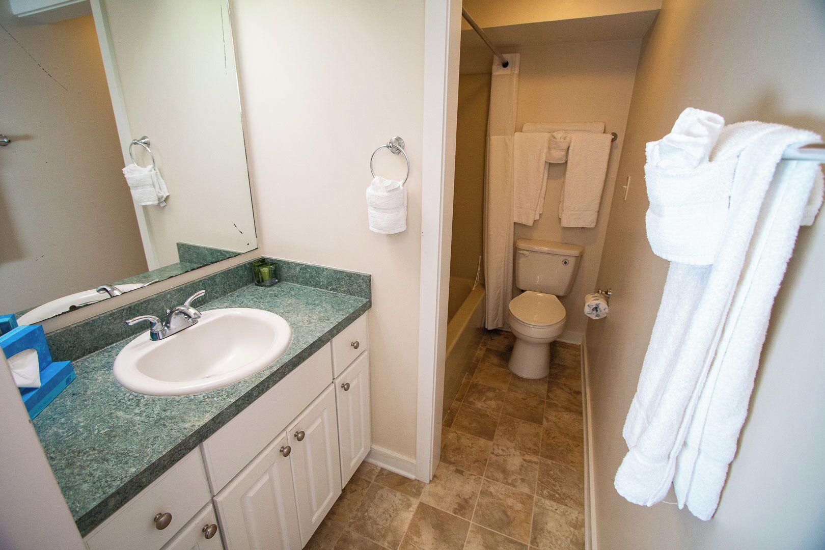 A bathroom with a sink, toilet, and shower.