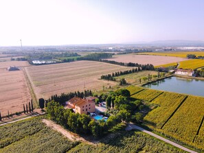 A rural landscape with fields, a pond, and a building with a swimming pool. - Pinzale farmhouse, swimming pool, air conditioning,  for families and friends (Latignano)