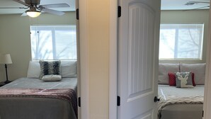 A bedroom with a bed, a ceiling fan, and a window with blinds. - Downtown Taber Street Railroad 🚂 House - Great Location!! (Williams)