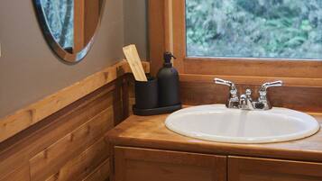 Bathtub, hair dryer, towels, toilet paper