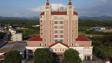 A multi-story building with a symmetrical facade, large windows, and a central entrance.