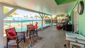 A covered outdoor area with a pool, chairs, and a kitchen area. - Heated Pool/Hot tub in heart of Tempe/ASU/Scottsdale (Tempe)