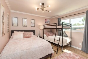 A bedroom with a bunk bed, a large bed, and a ceiling light fixture. - Heated Pool/Hot tub in heart of Tempe/ASU/Scottsdale (Tempe)