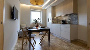 City Apartment | Living area | 43-inch flat-screen TV with cable channels, TV