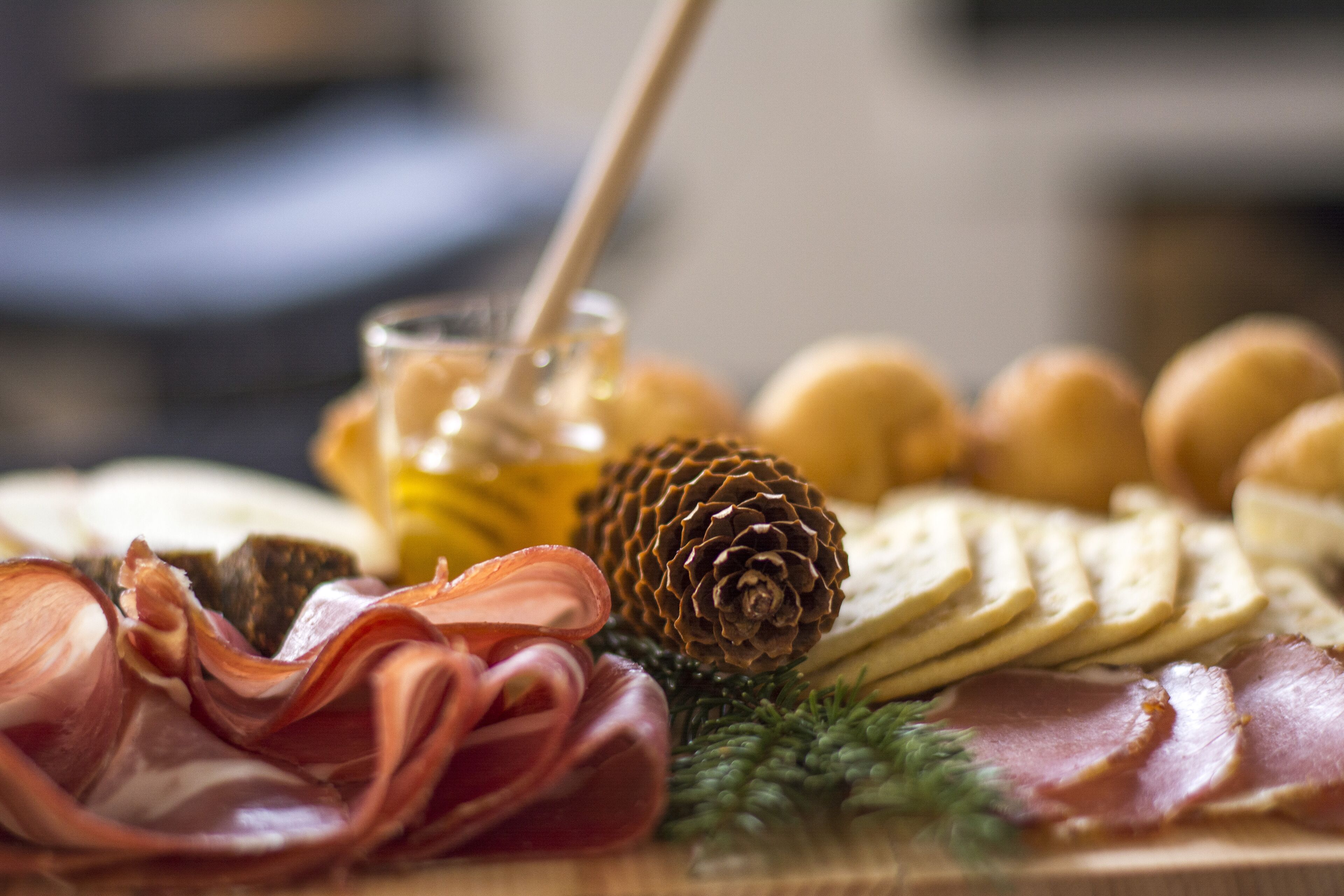 A charcuterie board with various meats, cheeses, and crackers.