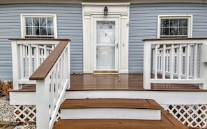 Welcome to 2707, a charming home with a front porch and white door.