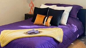 A bed with a purple bedspread, multiple pillows, and a blanket. - Marines peaceful retreat, The Spiral @ AbbeyAcres Near Beach with Washer & Dryer (Holly Ridge)