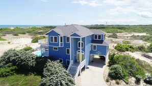 A two-story house with a balcony, a front porch, and a swimming pool. - Oceanside, 7 BRS, Private Pool, Hot Tub, Rec Room, OS1A, Corolla Horizons (Corolla)