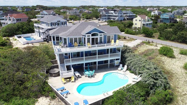 A large two-story house with a swimming pool, multiple decks, and outdoor seating areas. - Oceanside, 7 BRS, Private Pool, Hot Tub, Rec Room, OS1A, Corolla Horizons (Corolla)