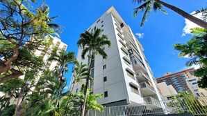 A tall, modern building with multiple balconies and a white facade. - Scandia 203 - Sleeps 6, Full Kitchen, Free Parking, and 1 Block to the Beach (Honolulu)