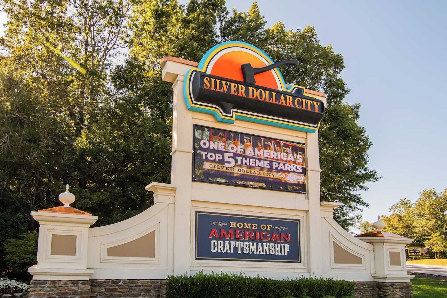 A sign for Silver Dollar City with a large screen displaying "ONE OF AMERICA'S TOP 5 THEME PARKS".