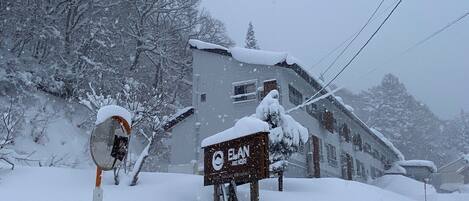 A snow-covered building with a signboard labeled "ELAN."