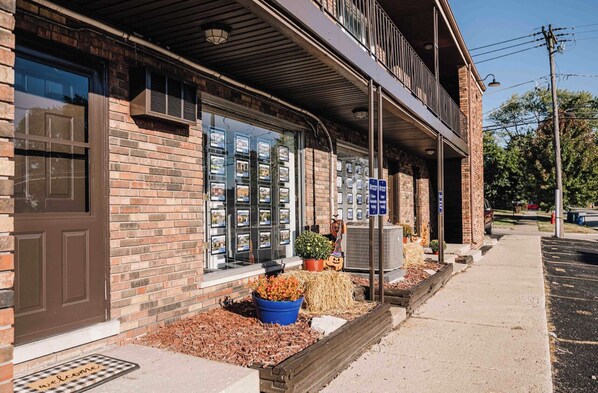 A brick building with a storefront displaying various items.