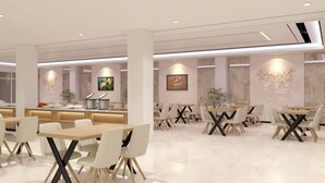 A modern dining area with white tables and chairs, a central counter with kitchen appliances, and artwork on the walls.
