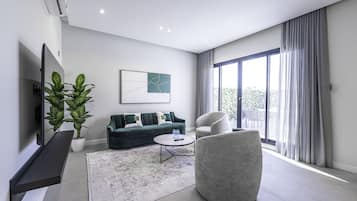 Departamento, 3 habitaciones | Área de sala de estar | Televisión LCD de 60 pulgadas con canales digitales y televisión