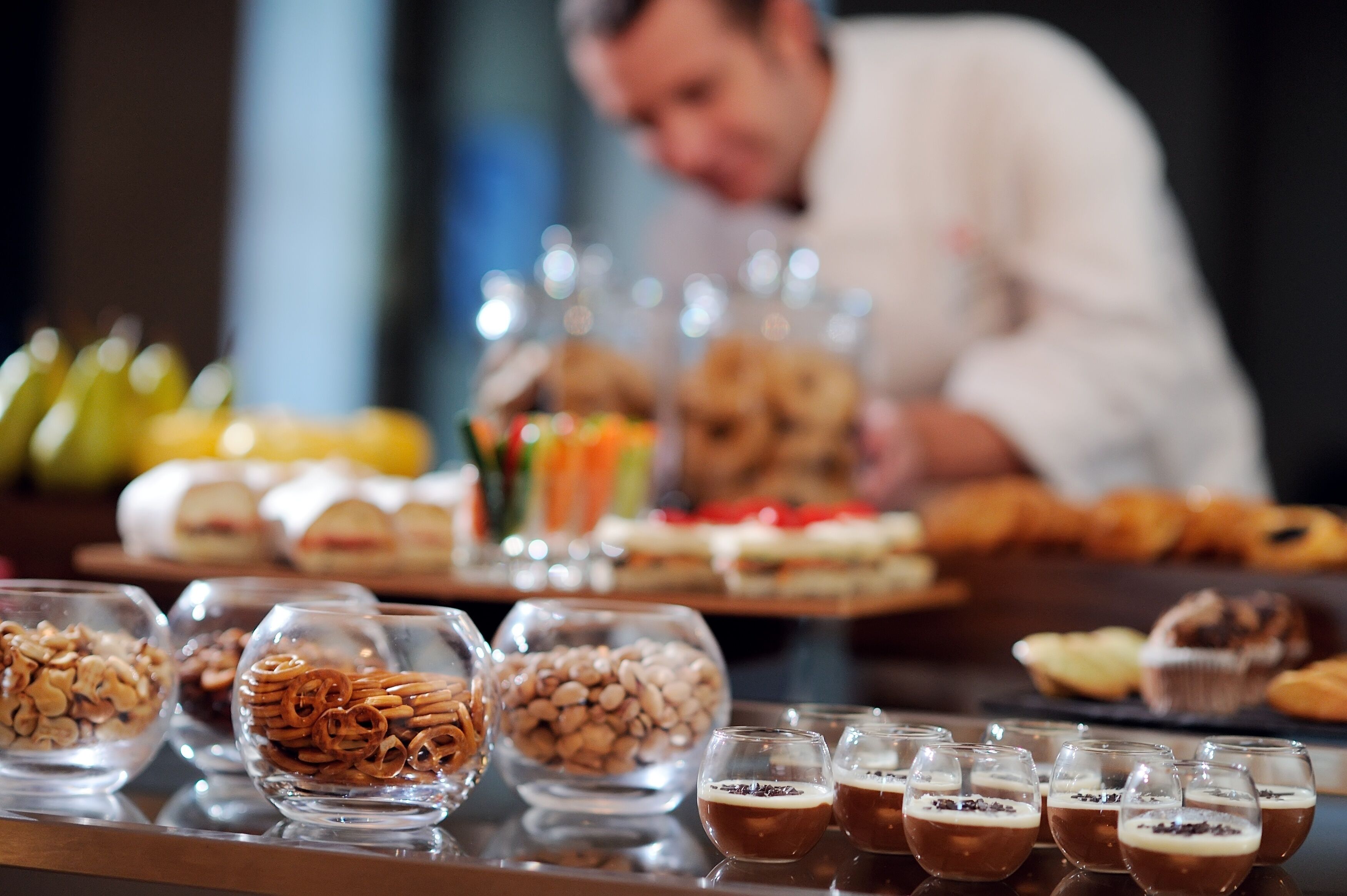 A buffet table with various food items and beverages.