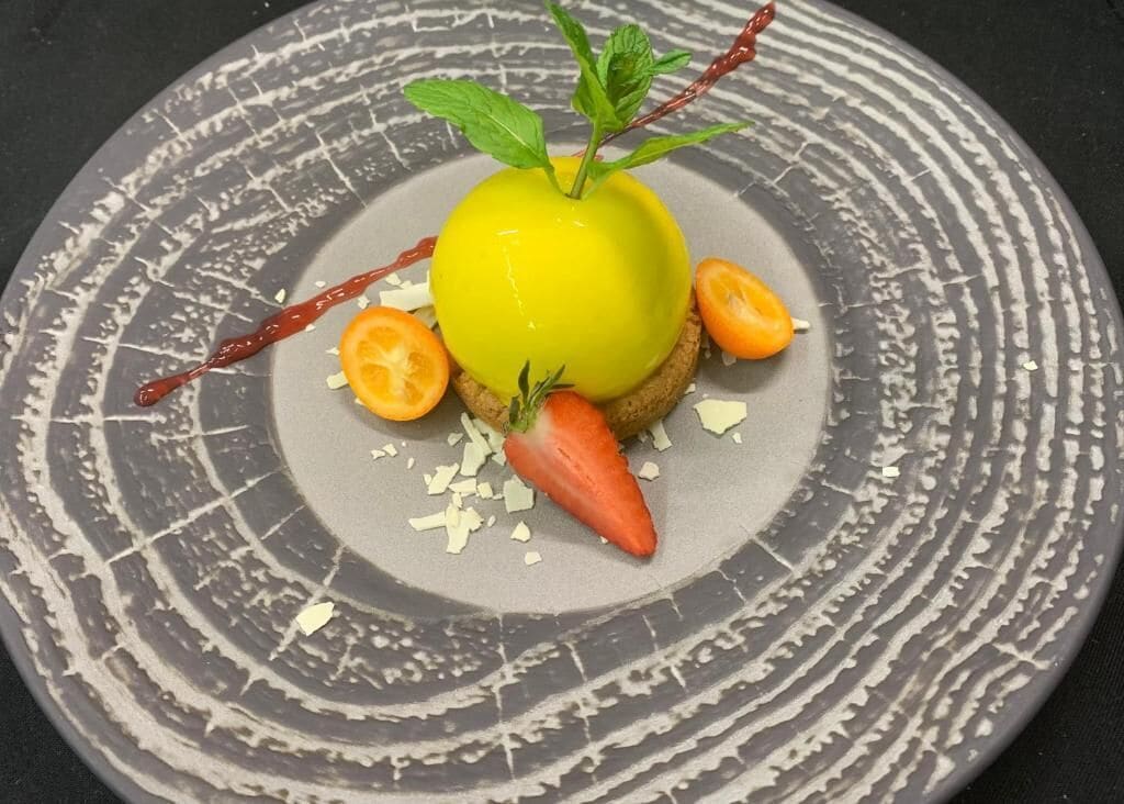 A dessert on a plate with a textured design.