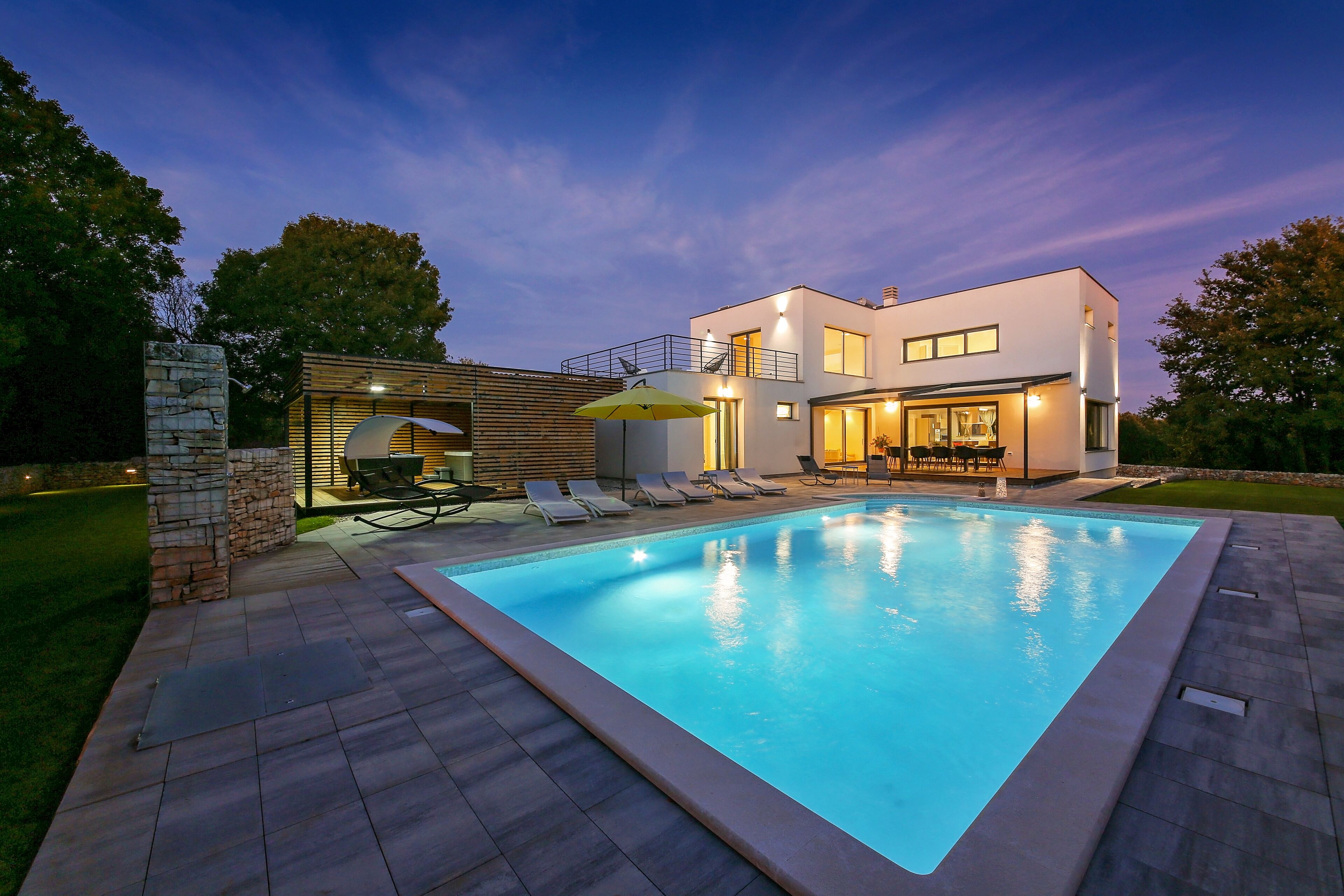 A heated pool, sun loungers