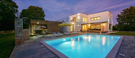 A heated pool, sun loungers